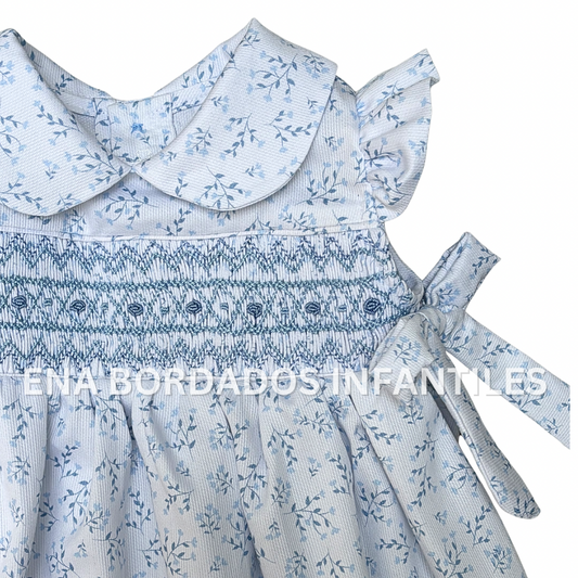 Vestido piqué blanco con flores celeste con panal y lacitas a los lados